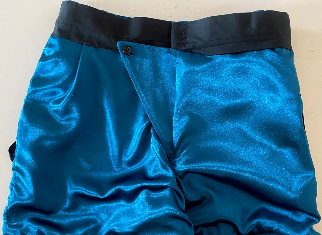 Stacy Stewart Smith Blue Lagoon Teal Flat Front Knit Windsor Shorts on mannequin 6'3" side lining view front flat on ivory surface..