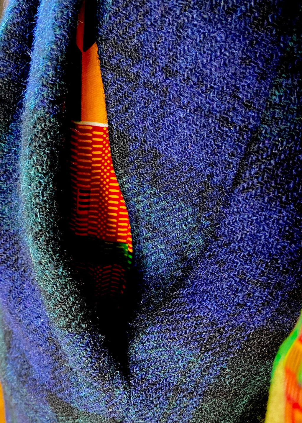 Close-up of Kente cloth pocketing inside front pocket of Stacy Stewart Smith's men's Blackwatch Plaid Harris Tweed© Pleated Windsor pants. 