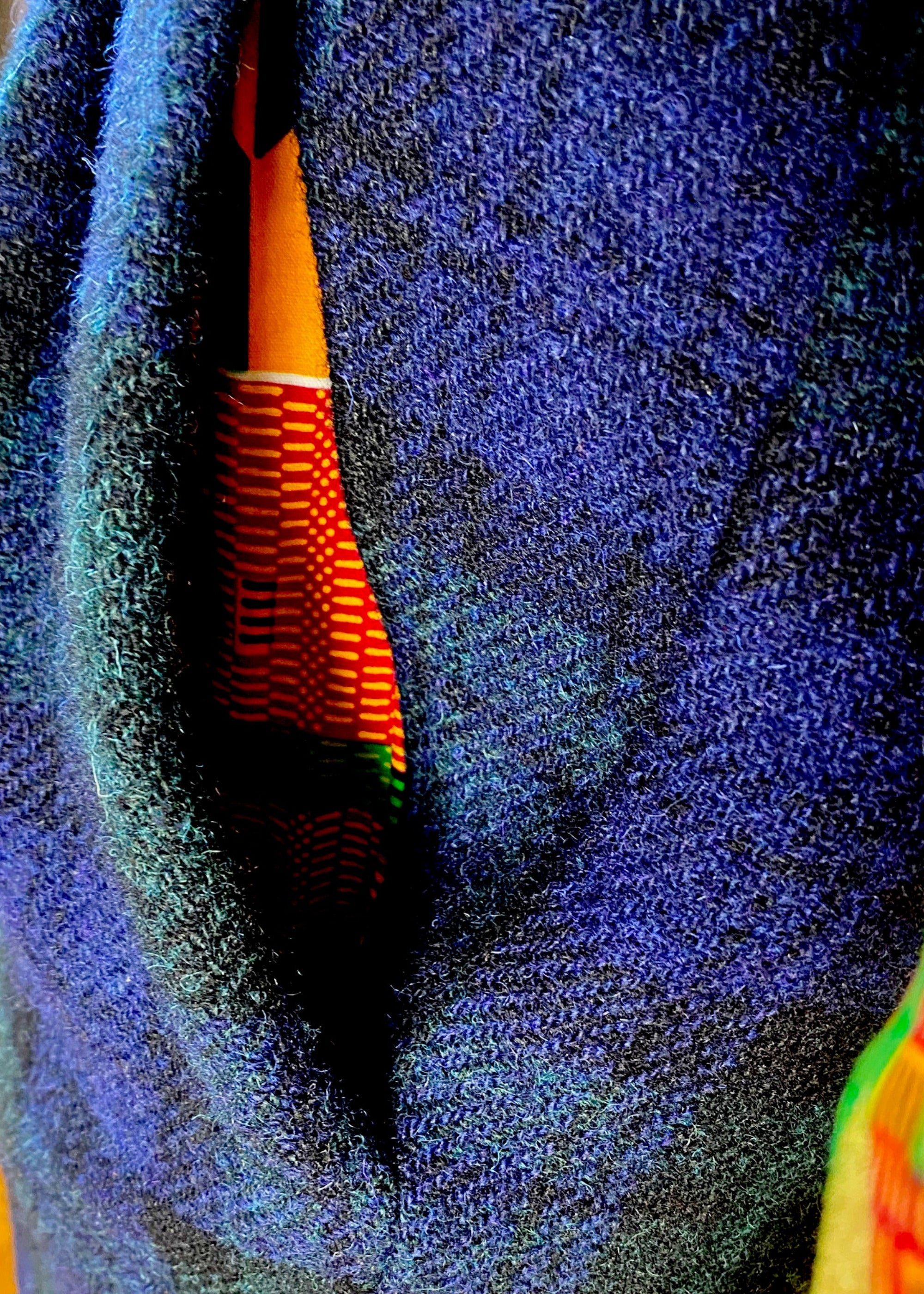 Close-up of Kente cloth pocketing inside front pocket of Stacy Stewart Smith's men's Blackwatch Plaid Harris Tweed© Pleated Windsor pants. 