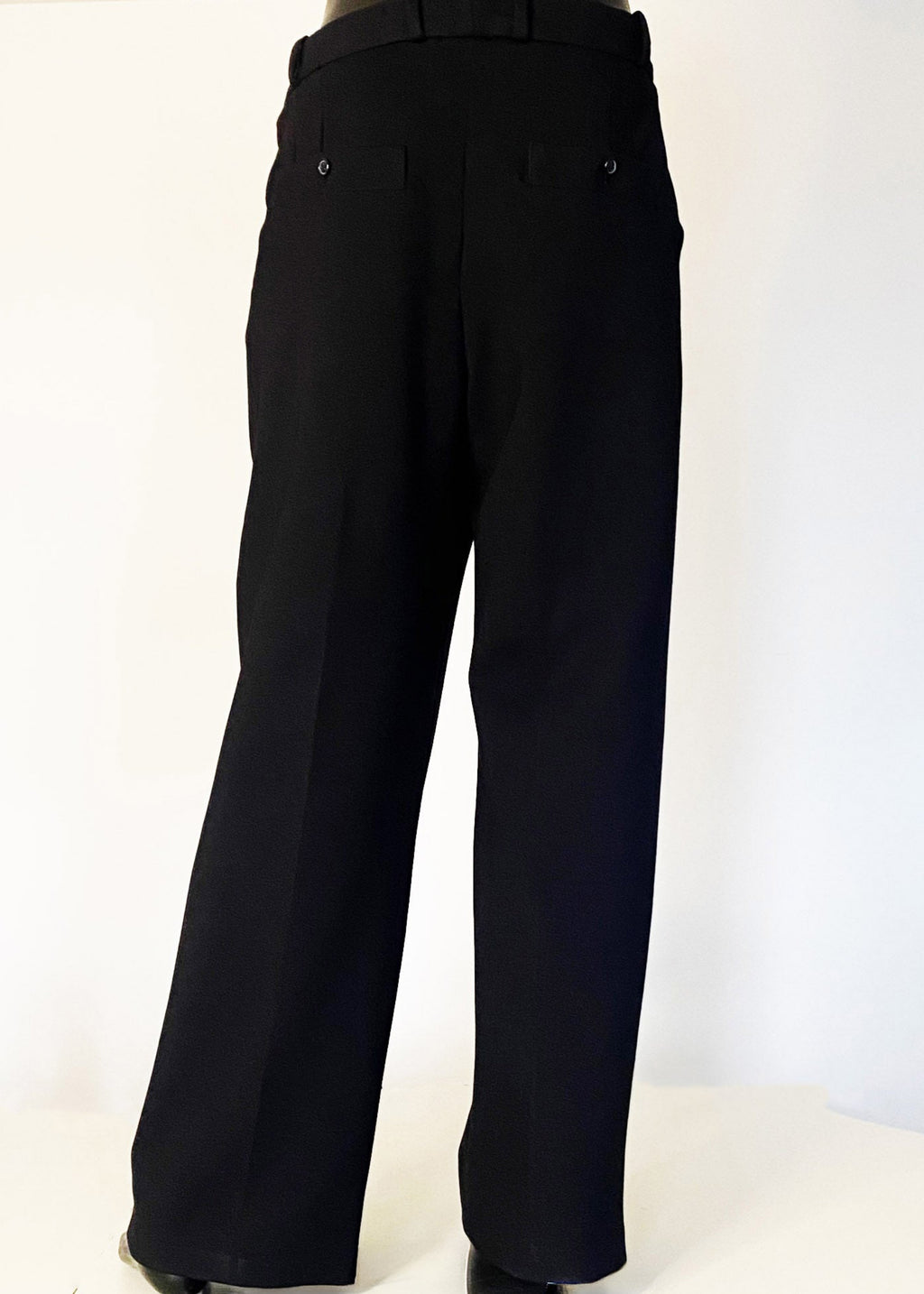 Stacy Stewart Smith Men's Black Knit Pleated Windsor Pants on mannequin 6'3" full back view with ivory backdrop. 