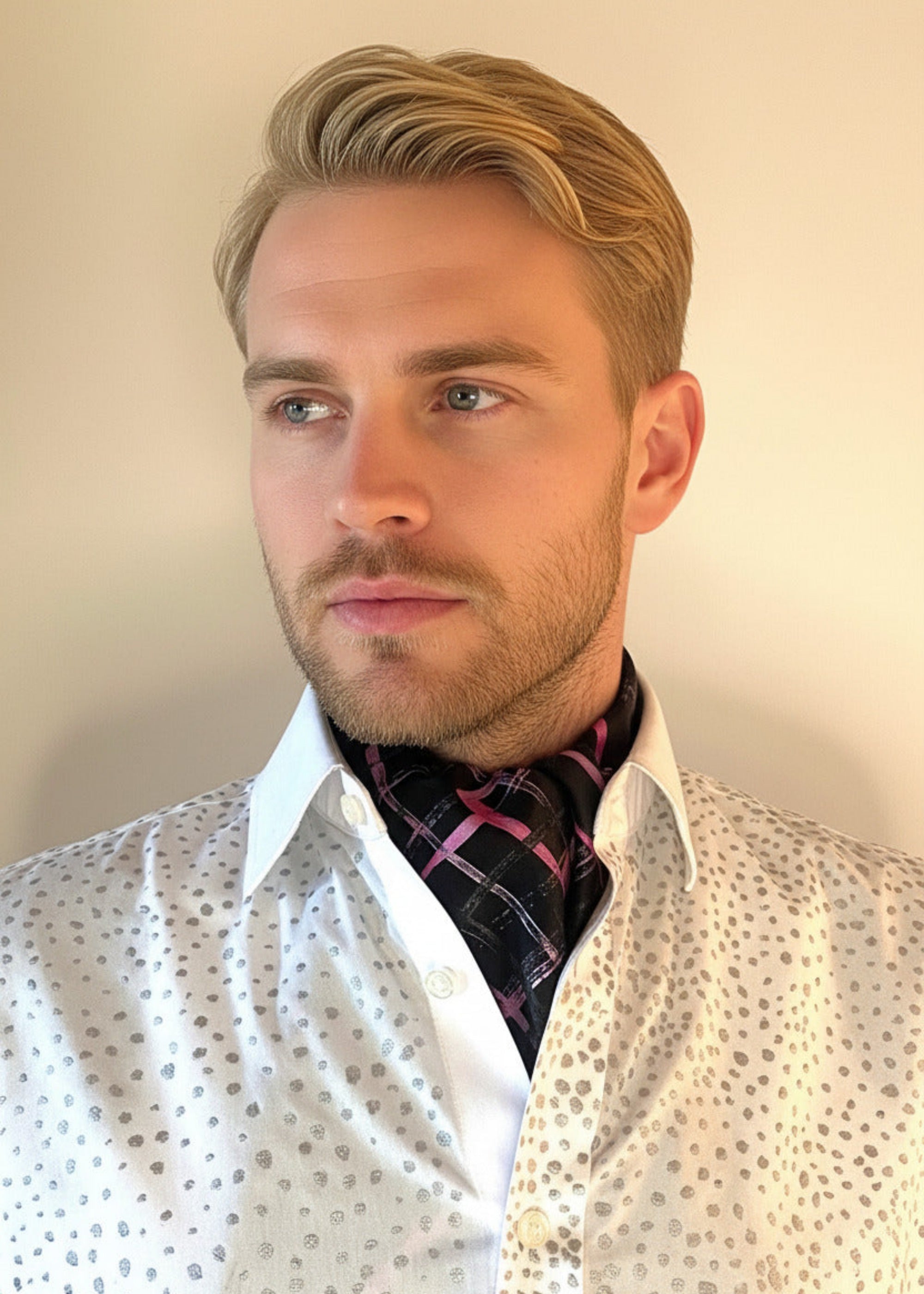 HOW TO TIE A CRAVAT: STEP 8 Atelier Quarterly presents Stacy Stewart Smith's Hand-Painted Cotton Percale Shirt and Hand-Painted Silk Cravat in Onyx/Shocking on a male mannequin front view with collar up against an ivory backdrop.