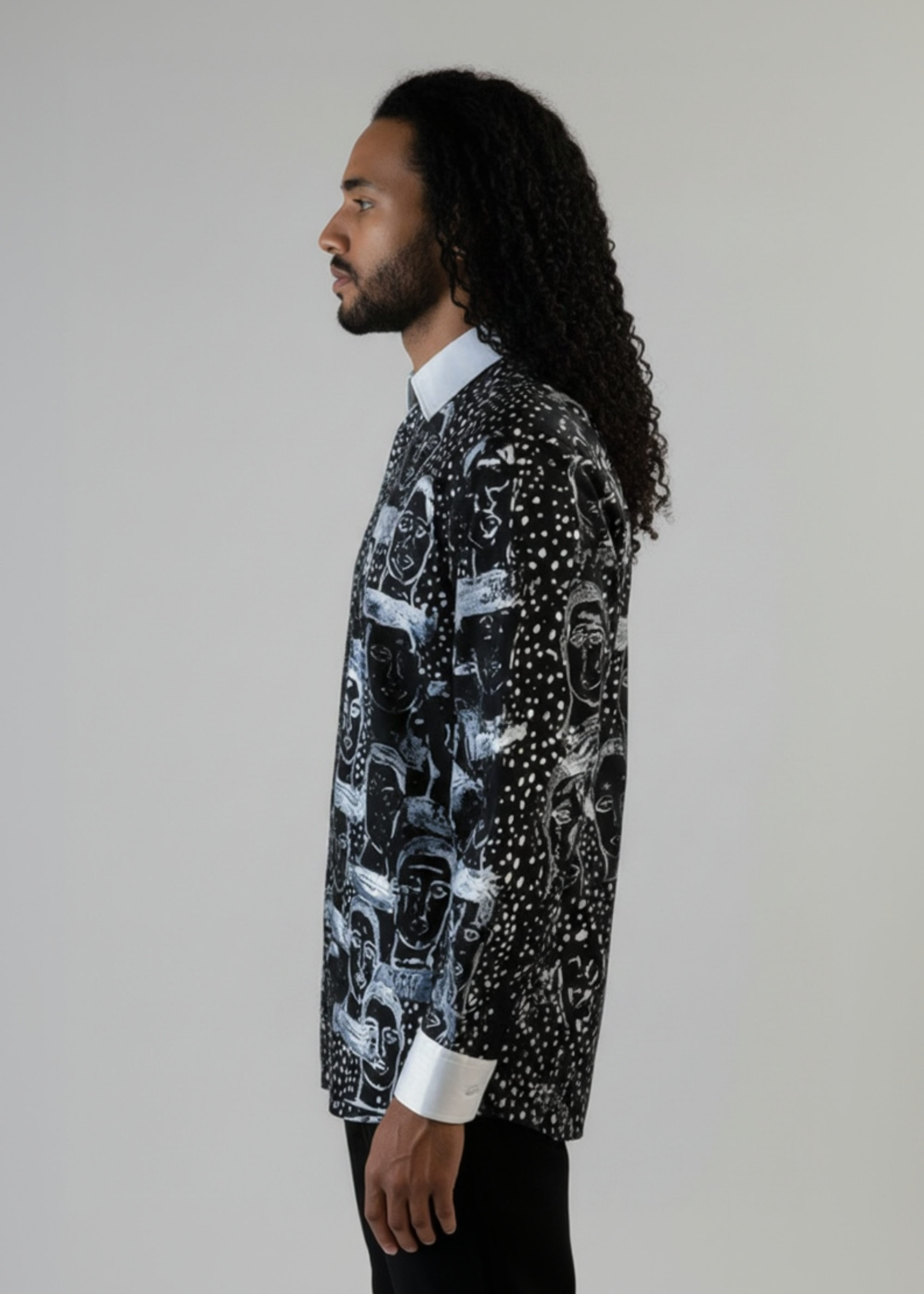 Stacy Stewart Smith Men’s Pawns in Silver on Black Hand-Painted Premium Cotton Percale Dress Shirt tucked into black suede pants on a mannequin 6'3" side view  in front of gray backdrop.