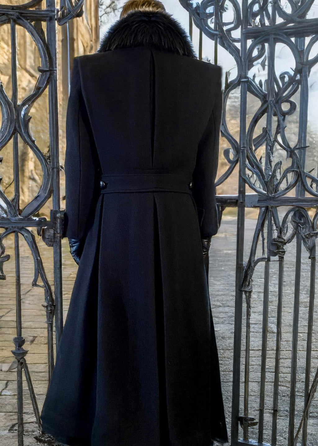 Stacy Stewart Smith Men's Harris Tweed Wool Processional Great Coat on mannequin 6'3" back view in front of a gate n England. 