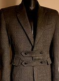 Stacy Stewart Smith — Highland Gentry Tweed Suit design study. Double-breasted belted tweed suit on mannequin, front detail view.