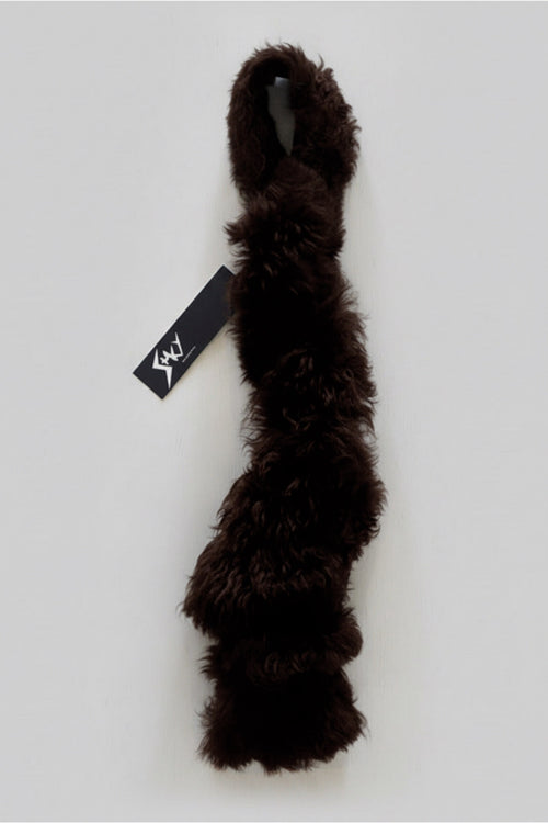 Stacy Stewart Smith Espresso Shearling & Leather Coil Scarf fur side with Stacy Couture hang tag against gray backdrop.