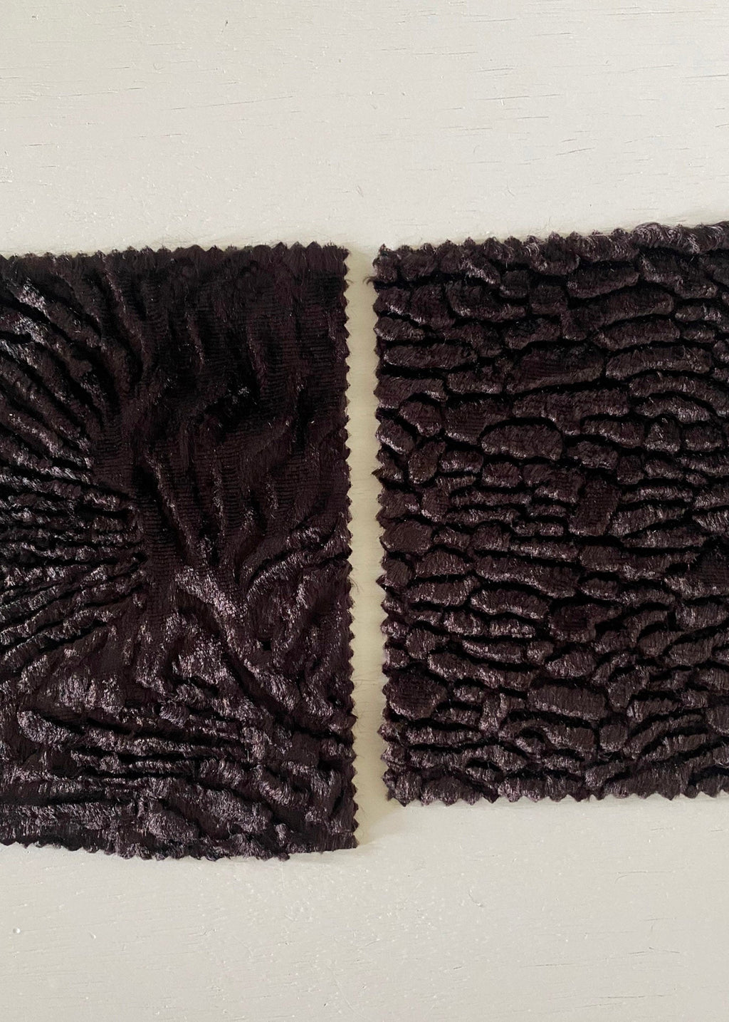 Stacy Stewart Smith sample swatches of Espresso sculptural pile fabrics available for Fall in Faux Persian Lamb and Woodgrain textures.