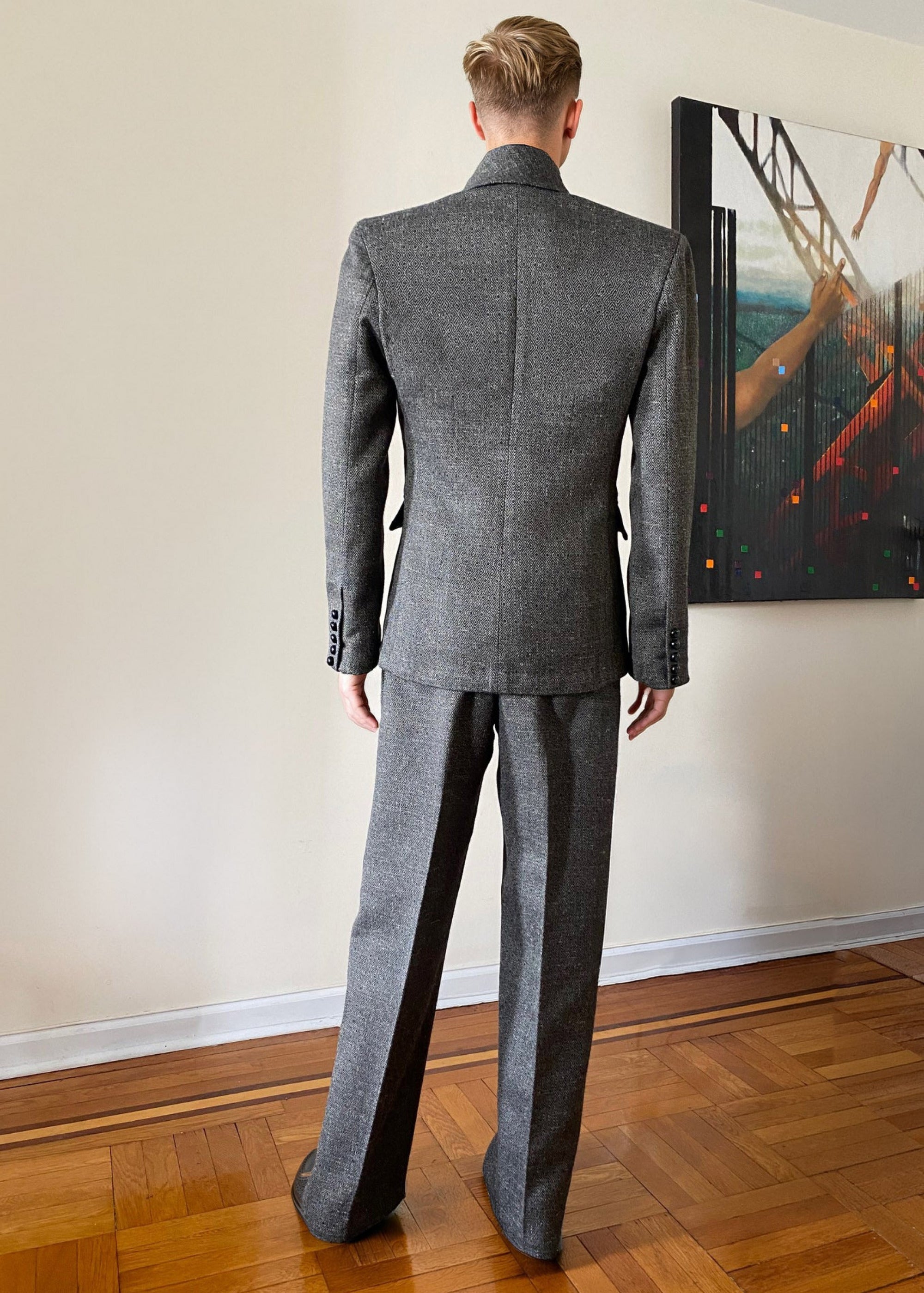 Stacy Stewart Smith Men's Highland Gentry Diamond Tweed Suit on mannequin 6'3" standing back view in a room with an Antique White wall, an oil painting entitled Faith on the wall, and on a wooden floor.
