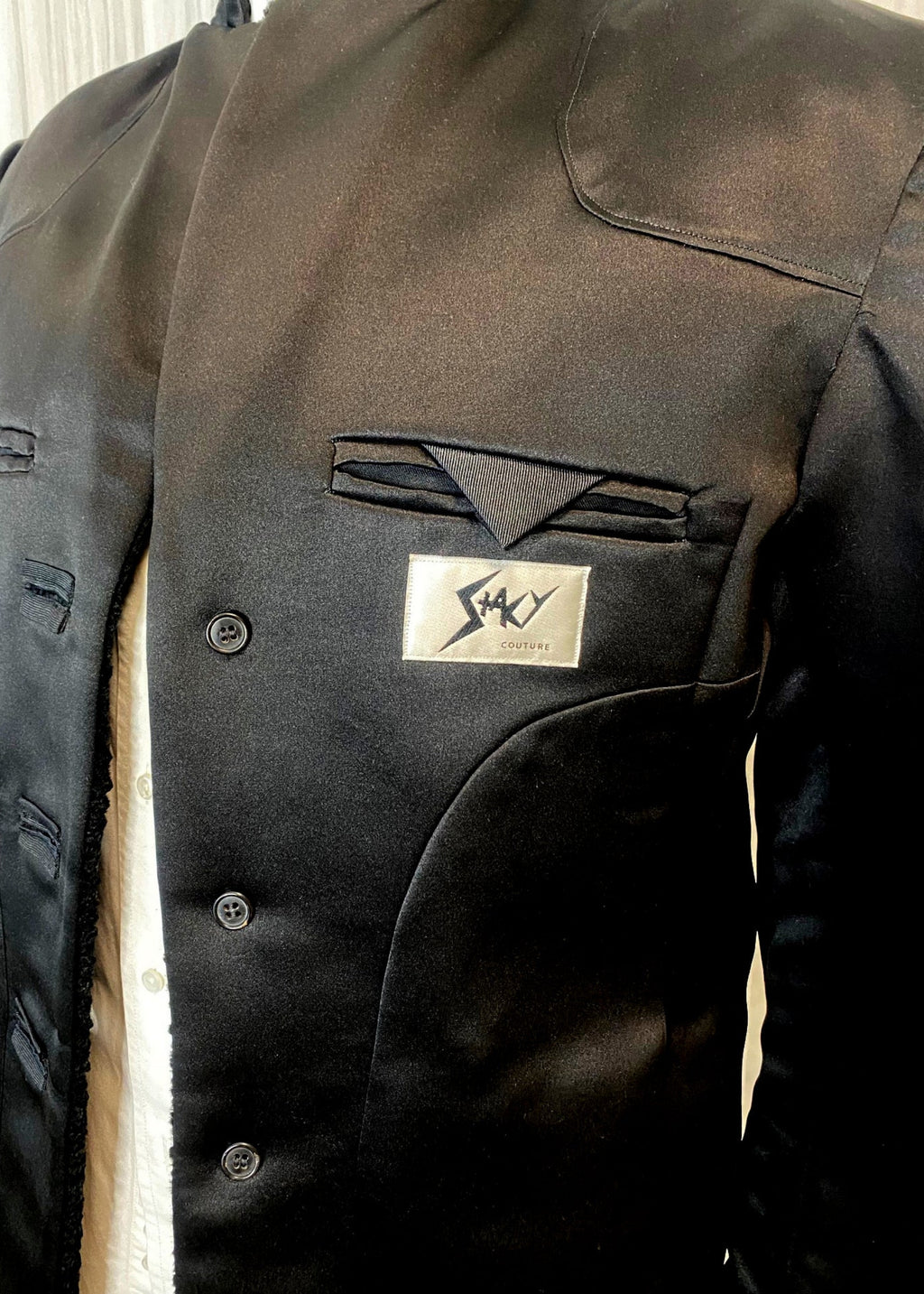 Stacy Stewart Smith Men's Faux Persian lamb Edwardian Abbreviated Tuxedo jacket lining and brand logo on form front view.