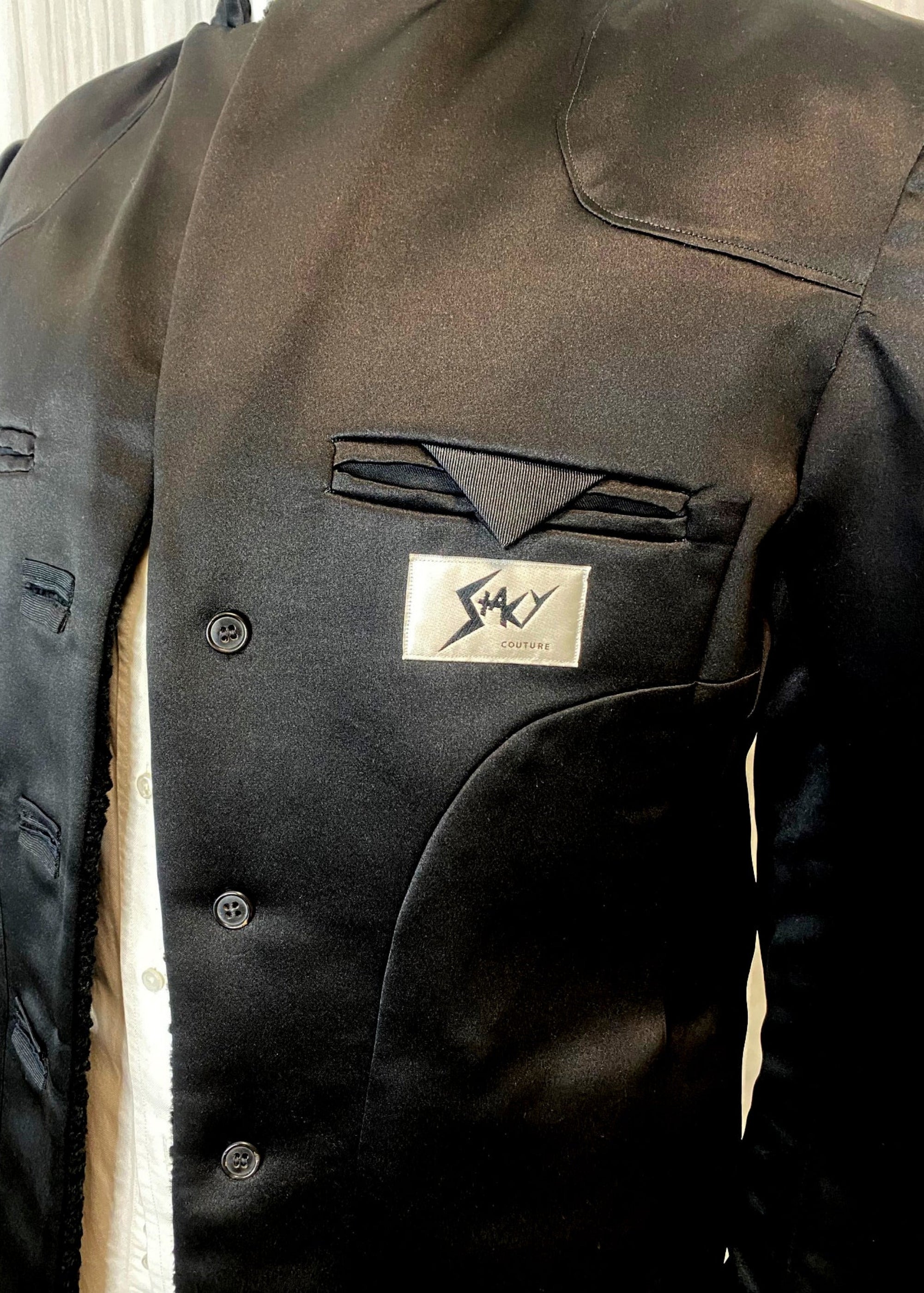 Stacy Stewart Smith Men's Faux Persian lamb Edwardian Abbreviated Tuxedo jacket lining and brand logo on form front view.